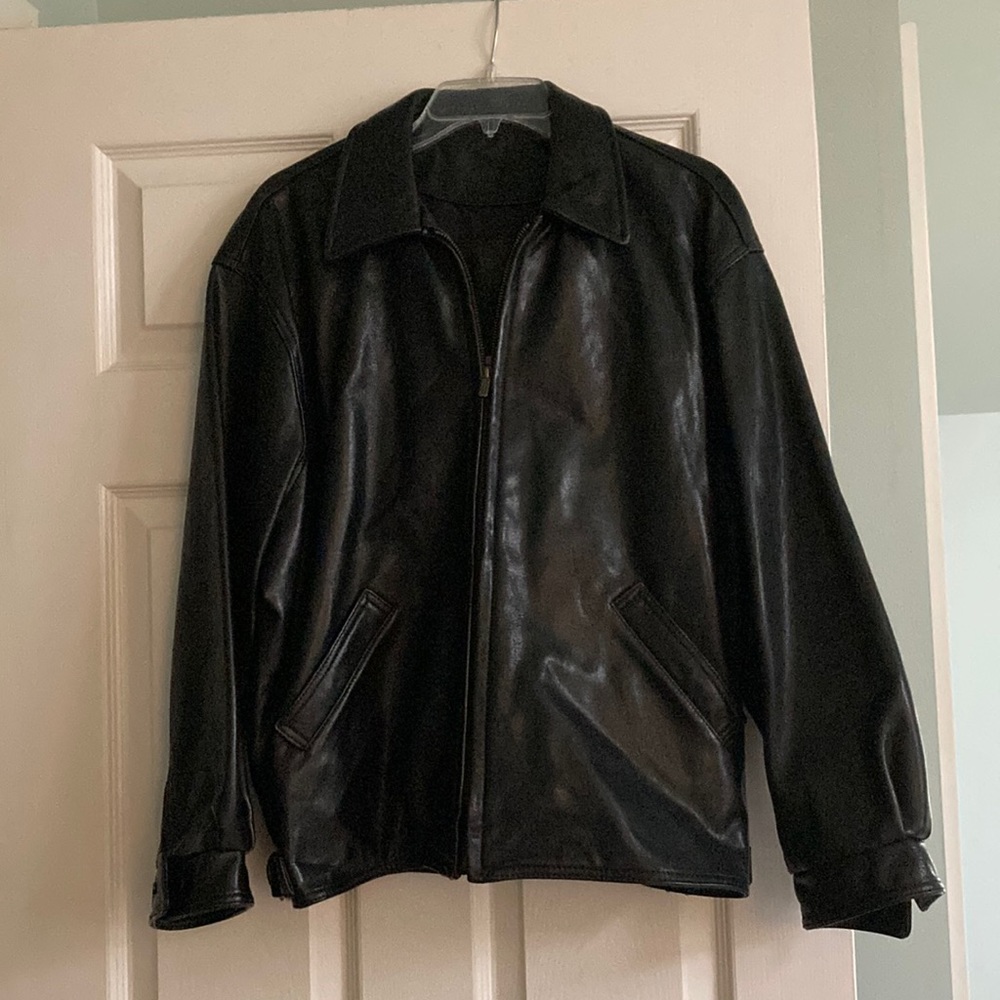 Coach leather jacket Snap buttons at wrist and front pockets.